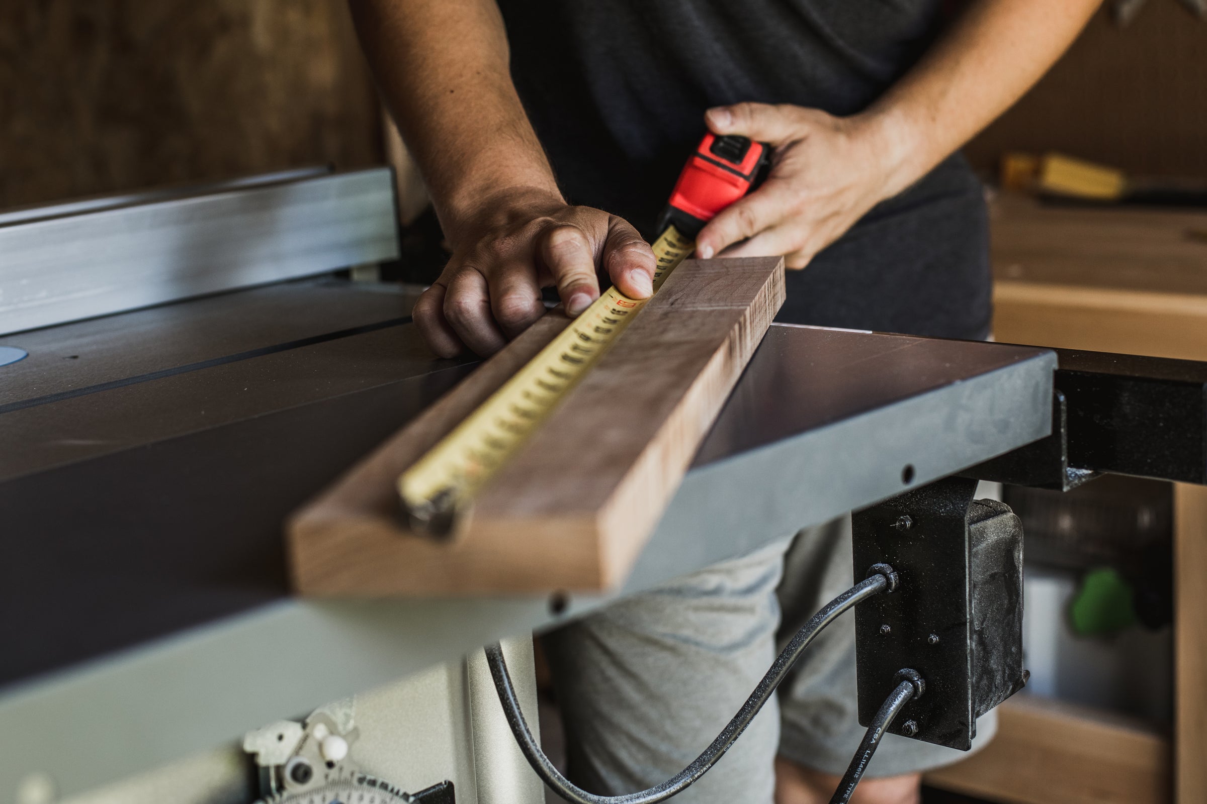 Contractor measuring wood